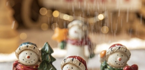 Detailed close-up of hand-painted resin snowmen with festive holiday decorations