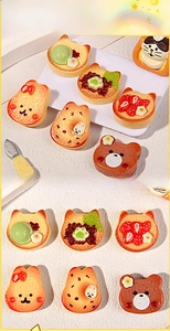 Macro view of assorted resin miniature cartoon toast for DIY hair clip crafts and accessories