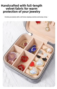 Top view of open velvet jewelry box with grey exterior and pink compartments