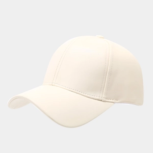 Detailed side view showing the smooth faux leather texture and seams of a cream baseball cap