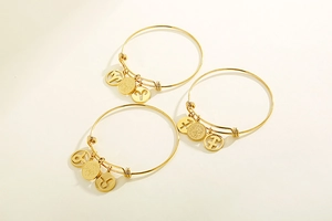 Adjustable gold plated zodiac bracelets featuring Aries, Taurus, and Sagittarius charms
