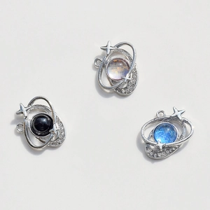 Macro detail of planet pendants with silver plating and colorful rhinestone accents