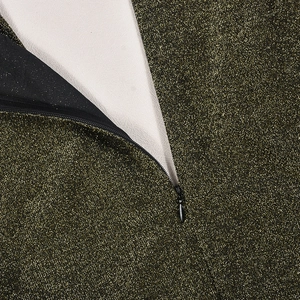 Dettaglio macro del tessuto con paillettes dorate con zip invisibile e fodera interna