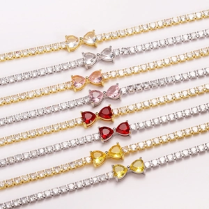 Multiple CZ tennis bracelets featuring heart-shaped bow designs in various colors