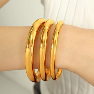 Three-piece set of 18K gold plated minimalist thick bangles with high polish finish