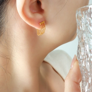 Elegant gold-plated triple bead chain tassel stud earrings for women on a model