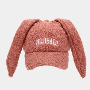 Detail showing the pink-brown teddy fleece texture and Colorado embroidery on rabbit ear cap