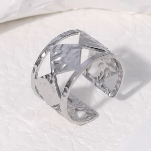 Macro shot of hammered silver stainless steel ring featuring geometric hollow pattern
