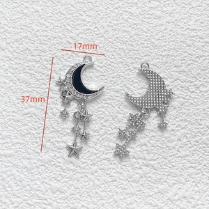 Detailed view of silver moon and star pendant with black enamel and rhinestones 17x37mm
