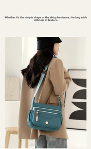 Detail of multi-layer peacock blue nylon crossbody bag with jacquard shoulder strap