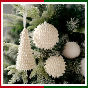 Detailed view of white foam Christmas balls and cone ornaments with fringe texture on tree