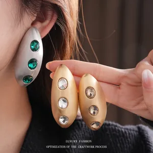 Brushed oval metal earrings with inlaid crystals and retro textured finish for women