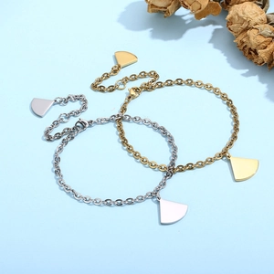 Detailed close-up of gold and silver fan-shaped charm bracelets on a blue background