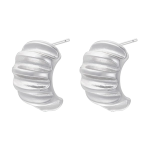 Macro detail of silver pleated arc earrings with textured wavy surface on white background
