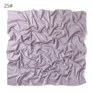 Detail view of the soft solid color imitation silk square scarf in elegant light purple.