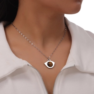 British retro eye shaped titanium steel necklace featuring a natural tiger eye stone
