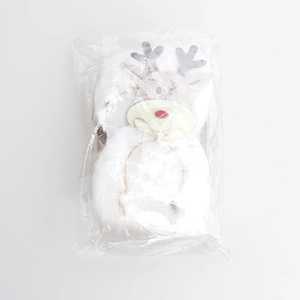 Detail of plush Christmas elk gift bag in plastic packaging with reindeer felt motif