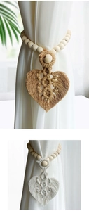 Detail of Boho curtain tiebacks with wood beads and handmade leaf tassels in ivory and wood