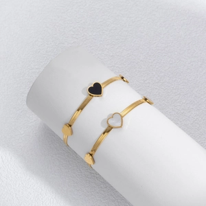 Minimalist gold snake chain bracelets with black enamel and white shell heart charms