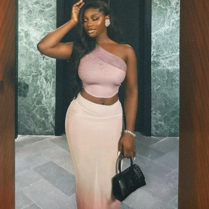 Pink gradient bodycon two-piece set with a diagonal one-shoulder crop top and long skirt