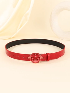 Detail of red crocodile texture belt with a sparkling red rhinestone lip-shaped buckle