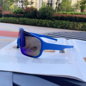 Close-up of blue cycling sports sunglasses with wrap-around lens on a magazine