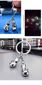 Detail showing high-gloss metallic boxing glove keychain pendants and engraving feature