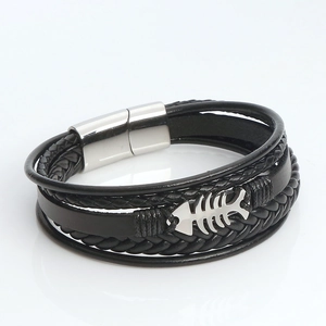 Detail view of multi-layer black braided leather bracelet with silver fishbone and magnetic clasp