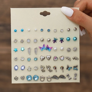 Detailed view of 30 pairs of assorted stud earrings including butterfly and flower motifs