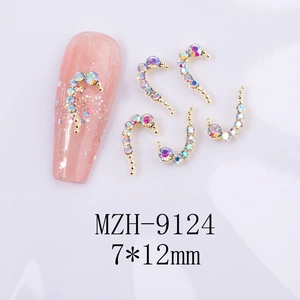 Macro shot of 7x12mm curved heart nail charms with AB rhinestones and gold base
