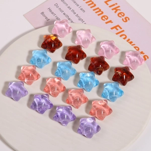 Colorful translucent resin star beads for DIY crafts on a white circular tray