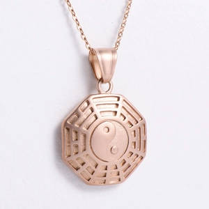 Detailed view of an octagonal Tai Chi Bagua pendant in elegant rose gold finish
