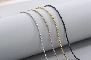 Macro detail of stainless steel snake chains in silver, rose gold, gold, and black finishes