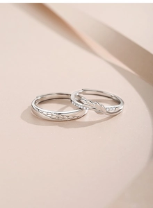 Detailed macro view of S925 sterling silver couple rings with wheat leaf pattern and diamonds