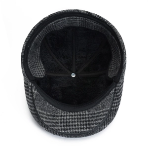 Detail view of the thick black fleece lining and grey plaid fabric of the winter cap