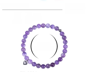Detail view of 6mm amethyst beaded bracelet with heart pendant and elastic band