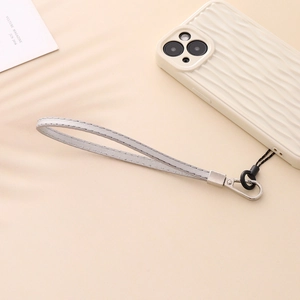 Detail of grey stitched PU leather phone wrist strap with silver metal clasp on case
