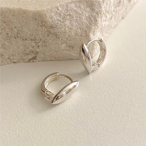 Detailed view of polished 925 sterling silver hoop earrings with olive shape charms