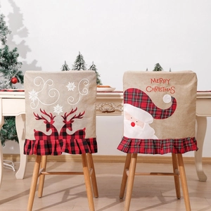 Detail of Christmas chair covers with Santa and reindeer embroidery on linen fabric