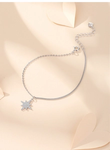 Close-up of S925 sterling silver star bracelet with zircon pendant and heart charm