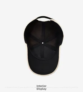 Detail view of the baseball cap's plush off-white exterior and black inner lining