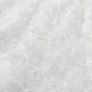 Detailed macro view of 3D white mesh roses and texture on a strapless evening gown