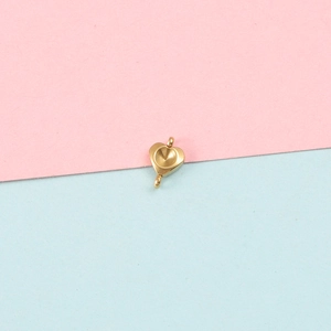 Close-up of golden heart-shaped stainless steel pendant base with dual connector loops