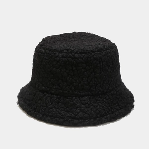 Close-up of soft black faux lamb wool texture on a warm winter bucket hat