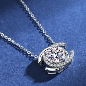 Macro view of a 2ct moissanite pendant with dual halo and brilliant round cut center stone