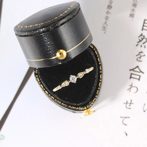 Gold plated minimalist zircon ring displayed in a black heart-shaped leather jewelry box