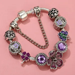 Purple charm bracelet featuring clover pendants and violet crystals on a snake chain