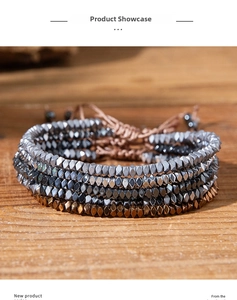 Detail of five-piece hematite beaded bracelet set with adjustable braided cord closures