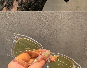 Detail of vintage square frame glasses with transparent rims and printed specifications