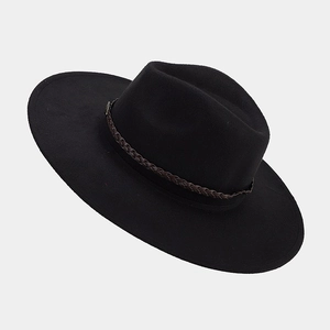 Detail of black wide brim felt hat with a brown braided leather band decoration